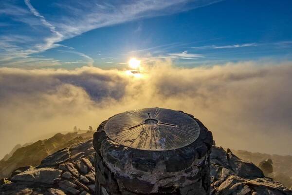 Summit view from Yr Wyddfa above the clouds at sunrise in Eryri