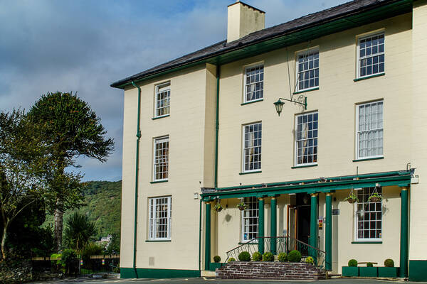 Front exterior of the Royal Victoria Hotel in Llanberis, showing the cream and green building set against the Snowdonia landscape.